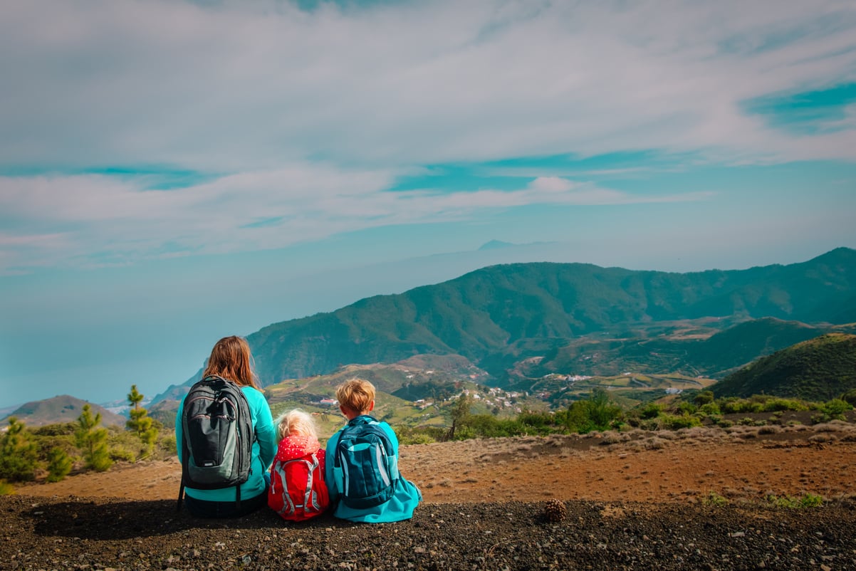 Mother with kids travel in mountains, family hiking